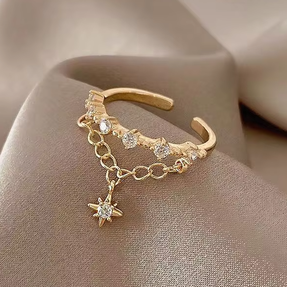 Gold open ring with star pendant