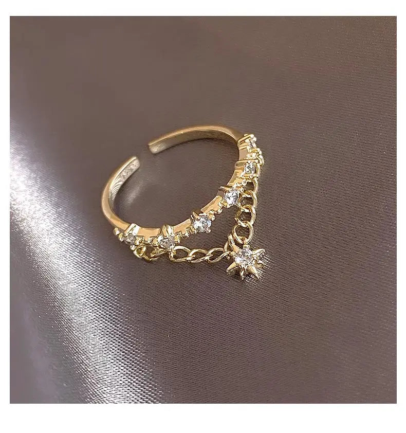 Gold open ring with star pendant